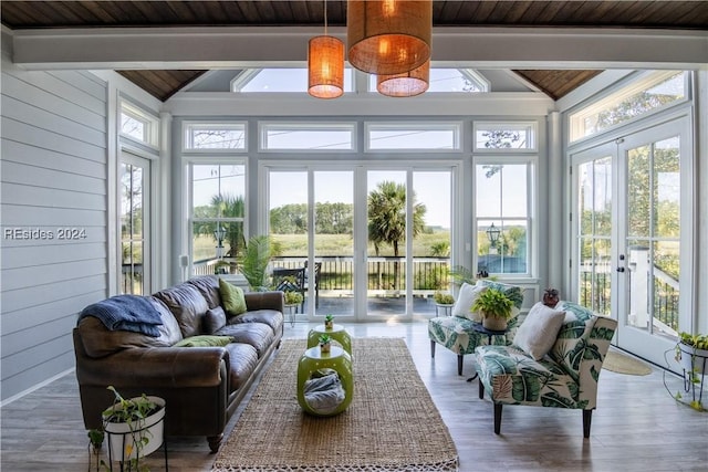 sunroom / solarium with wood ceiling, lofted ceiling with beams, and french doors