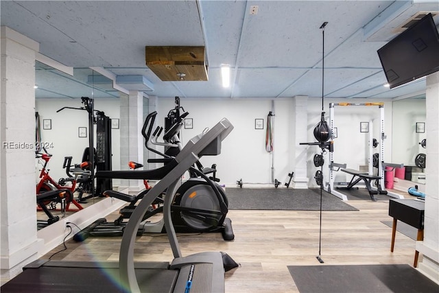 workout area with hardwood / wood-style flooring