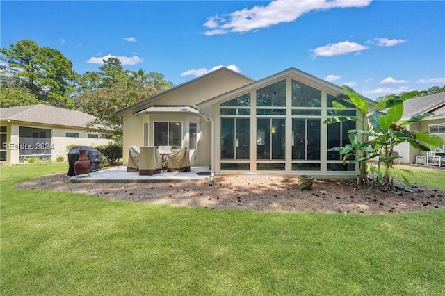 rear view of property with a yard and a patio area