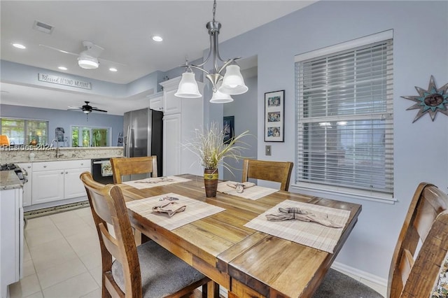 dining room with ceiling fan, sink, and light tile patterned floors