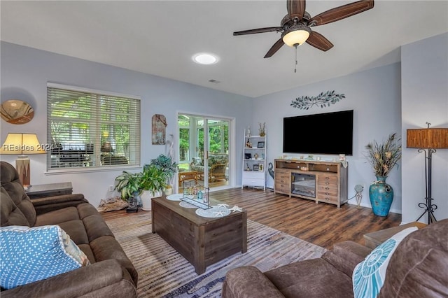 living room featuring hardwood / wood-style flooring and ceiling fan