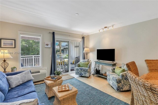 living room featuring light tile patterned floors, crown molding, track lighting, and an AC wall unit