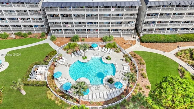 view of pool featuring a patio area and a lawn