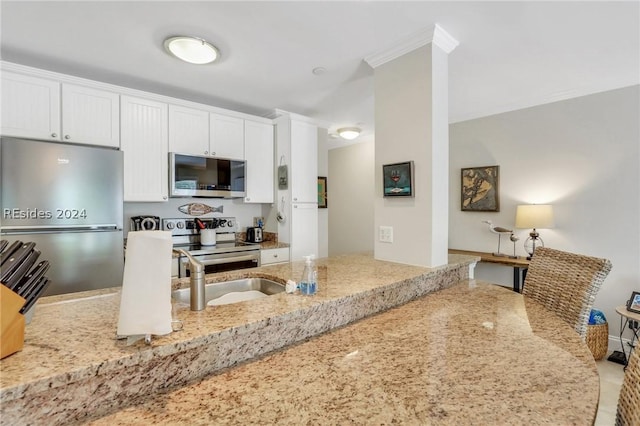 kitchen with light stone countertops, appliances with stainless steel finishes, and white cabinets