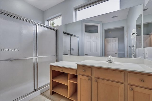 bathroom with vanity, tile patterned flooring, and a shower with door