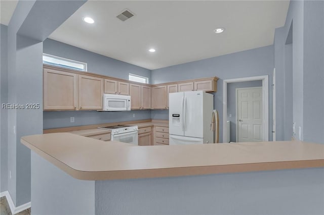 kitchen with white appliances, light brown cabinetry, sink, and kitchen peninsula