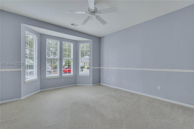 carpeted spare room with ceiling fan and a healthy amount of sunlight