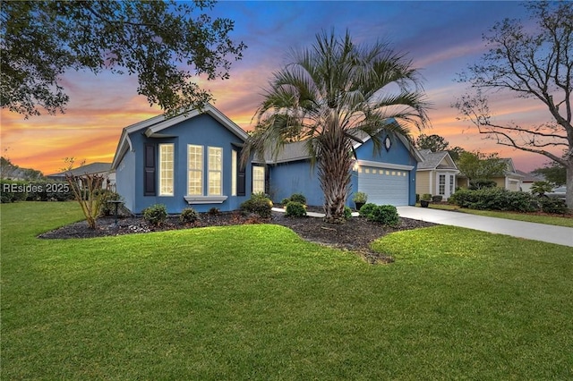 ranch-style home with a garage and a lawn