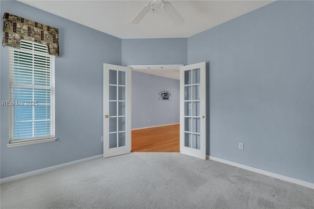 empty room featuring carpet floors, french doors, and ceiling fan