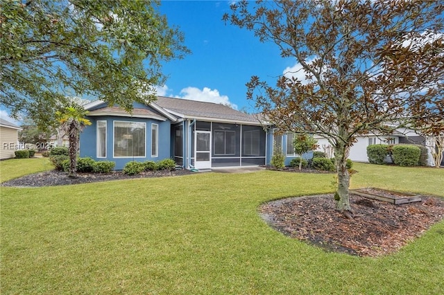 view of front of house featuring a sunroom and a front yard