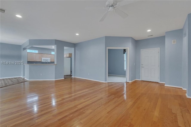 unfurnished living room featuring ceiling fan and light hardwood / wood-style floors