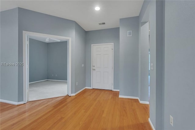 hallway with light hardwood / wood-style floors