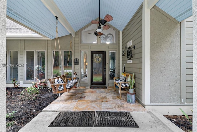 view of exterior entry with ceiling fan