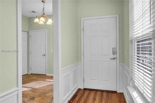 foyer featuring a chandelier and hardwood / wood-style floors