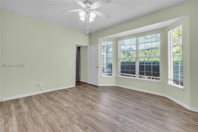 unfurnished room with ceiling fan and light hardwood / wood-style flooring