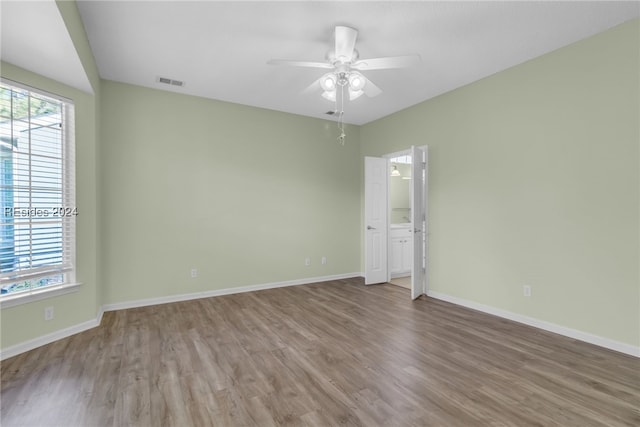 unfurnished room featuring hardwood / wood-style floors and ceiling fan