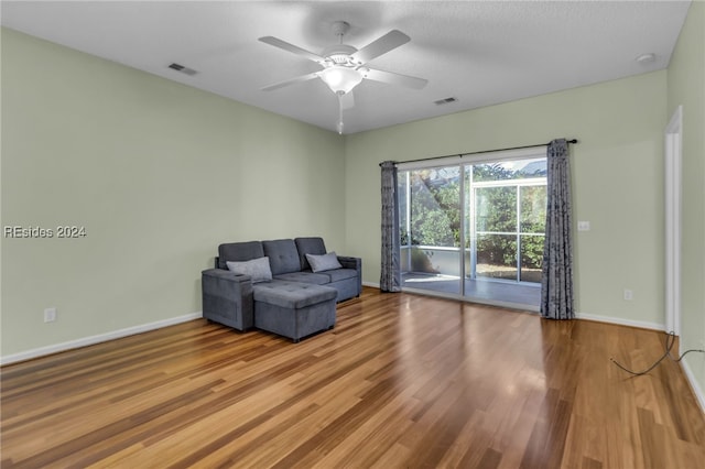 sitting room with hardwood / wood-style flooring and ceiling fan