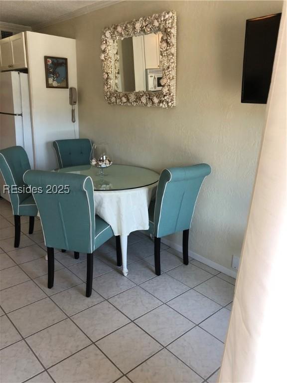 dining area featuring light tile patterned floors