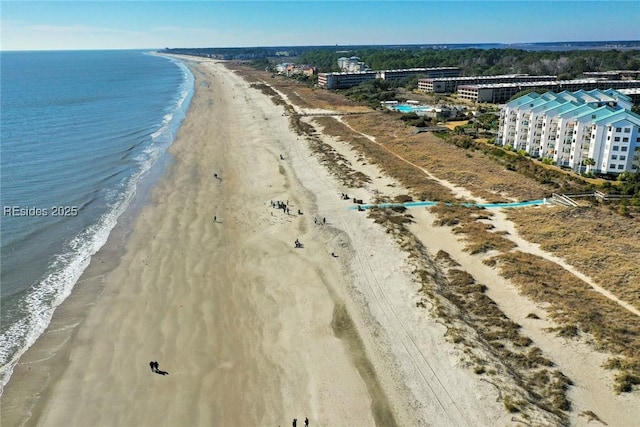 birds eye view of property featuring a beach view and a water view