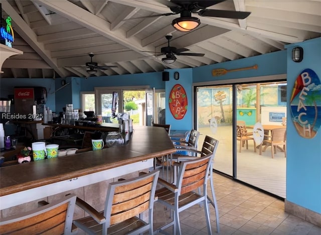 interior space featuring ceiling fan and vaulted ceiling with beams