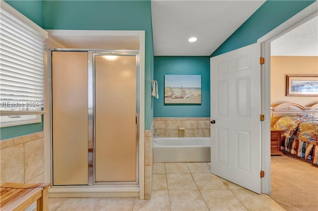 bathroom with shower with separate bathtub and tile patterned floors