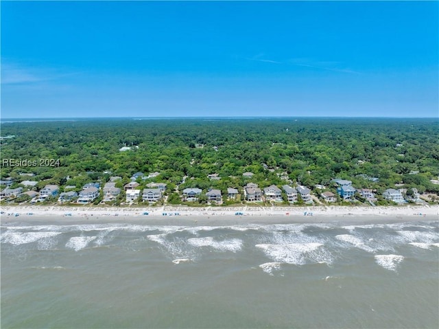 birds eye view of property featuring a water view and a beach view