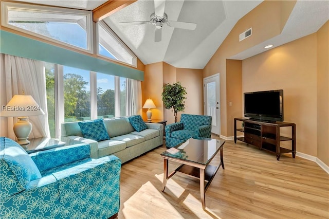 living room with vaulted ceiling with beams, ceiling fan, and light wood-type flooring