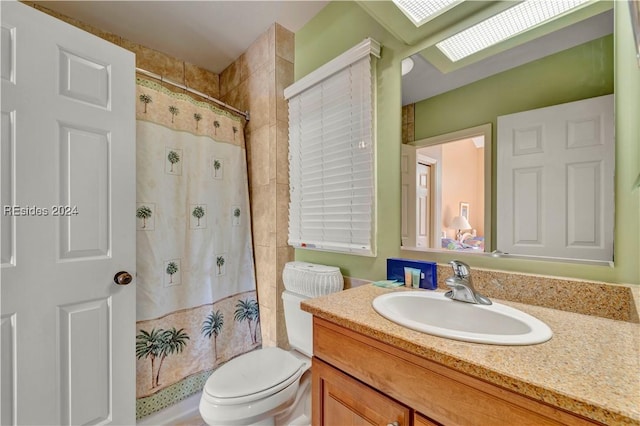 bathroom featuring vanity, a shower with shower curtain, and toilet