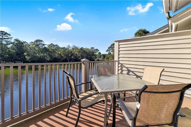 balcony featuring a deck with water view