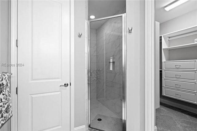 bathroom featuring a shower with shower door