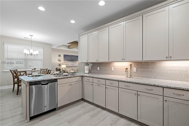 kitchen featuring sink, stainless steel dishwasher, light stone counters, kitchen peninsula, and light hardwood / wood-style flooring