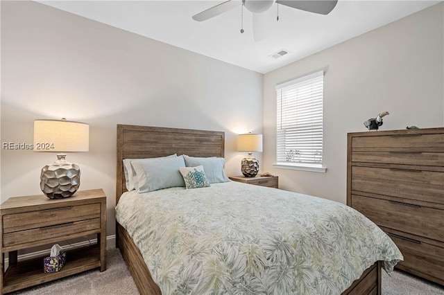 bedroom with light colored carpet and ceiling fan