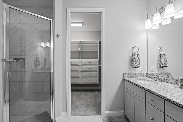 bathroom with vanity and a shower with shower door