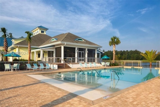 view of pool with a patio and a sunroom