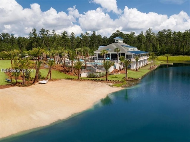 exterior space with a water view and a lawn