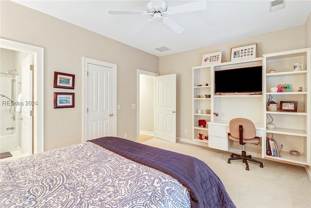 carpeted bedroom with ceiling fan and ensuite bath