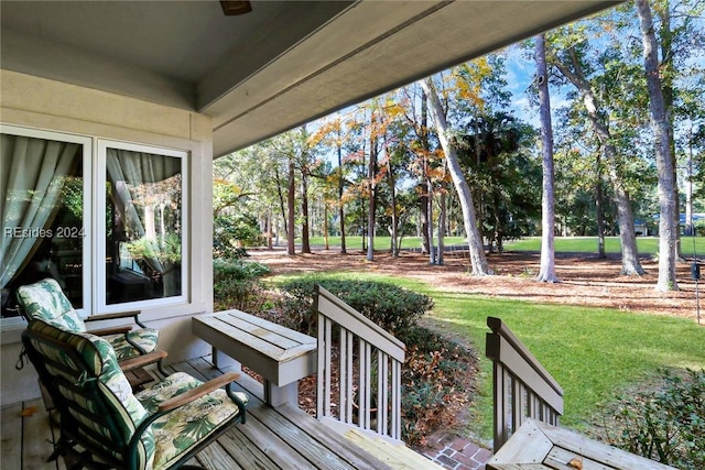 wooden terrace with a lawn