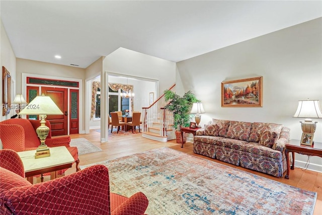 living room with wood-type flooring and a notable chandelier