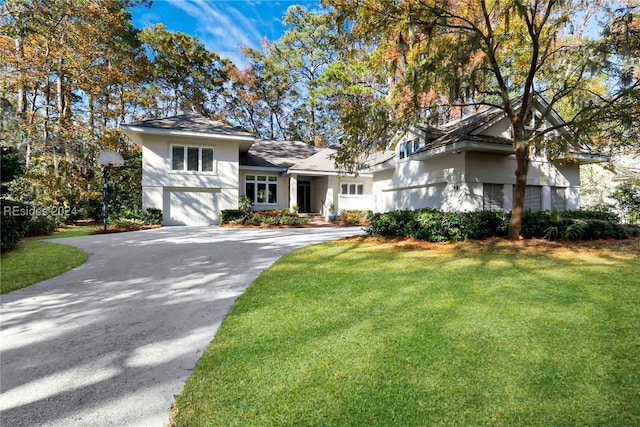 view of front of home featuring a garage and a front lawn