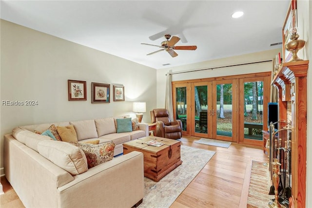 living room with ceiling fan and light hardwood / wood-style floors