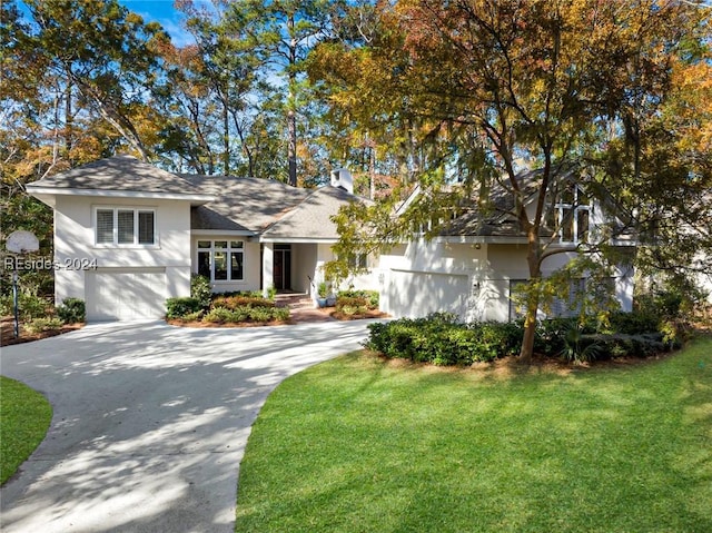 view of front facade with a garage and a front lawn