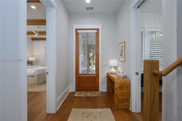 entrance foyer featuring beam ceiling and hardwood / wood-style flooring