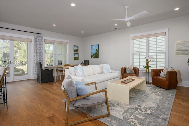 living room featuring light hardwood / wood-style flooring, french doors, and a healthy amount of sunlight