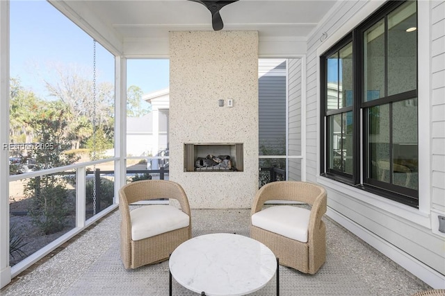 sunroom with a large fireplace