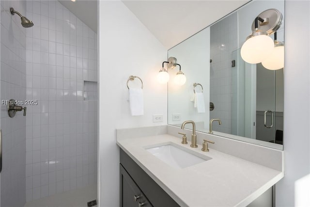 bathroom featuring a shower with door, vaulted ceiling, and vanity