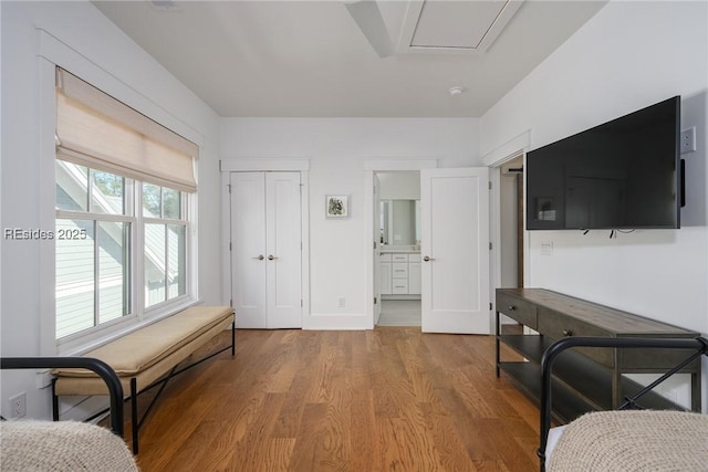 bedroom featuring hardwood / wood-style flooring, a closet, and ensuite bathroom