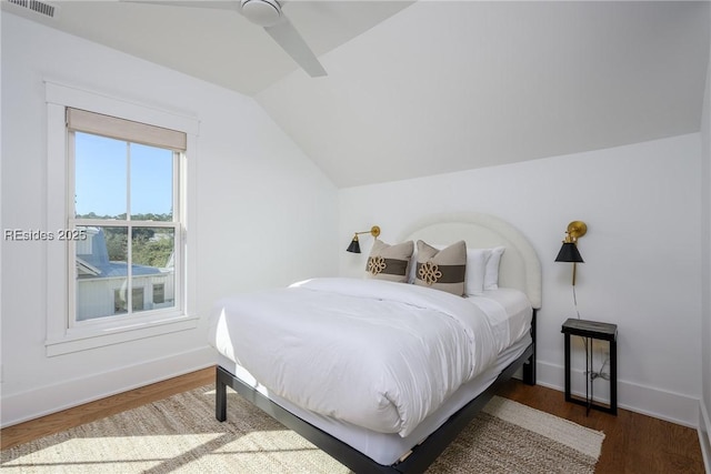 bedroom featuring lofted ceiling, dark hardwood / wood-style floors, and ceiling fan