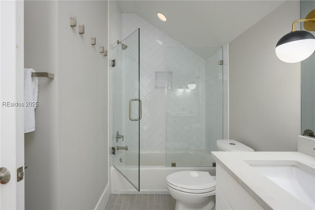 full bathroom featuring vanity, enclosed tub / shower combo, and toilet