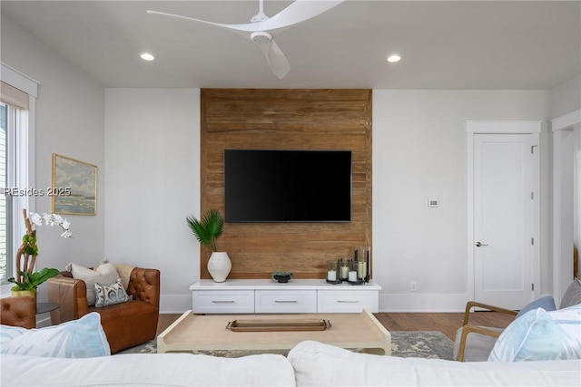 living room featuring wood-type flooring and ceiling fan