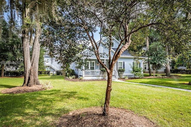 view of front of house featuring a porch and a front yard